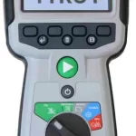 Handheld Megger TTRU1 transformer turns ratio tester with a color display showing 'Megger TTRU1' and a green play button, rotary dial, and mode controls.